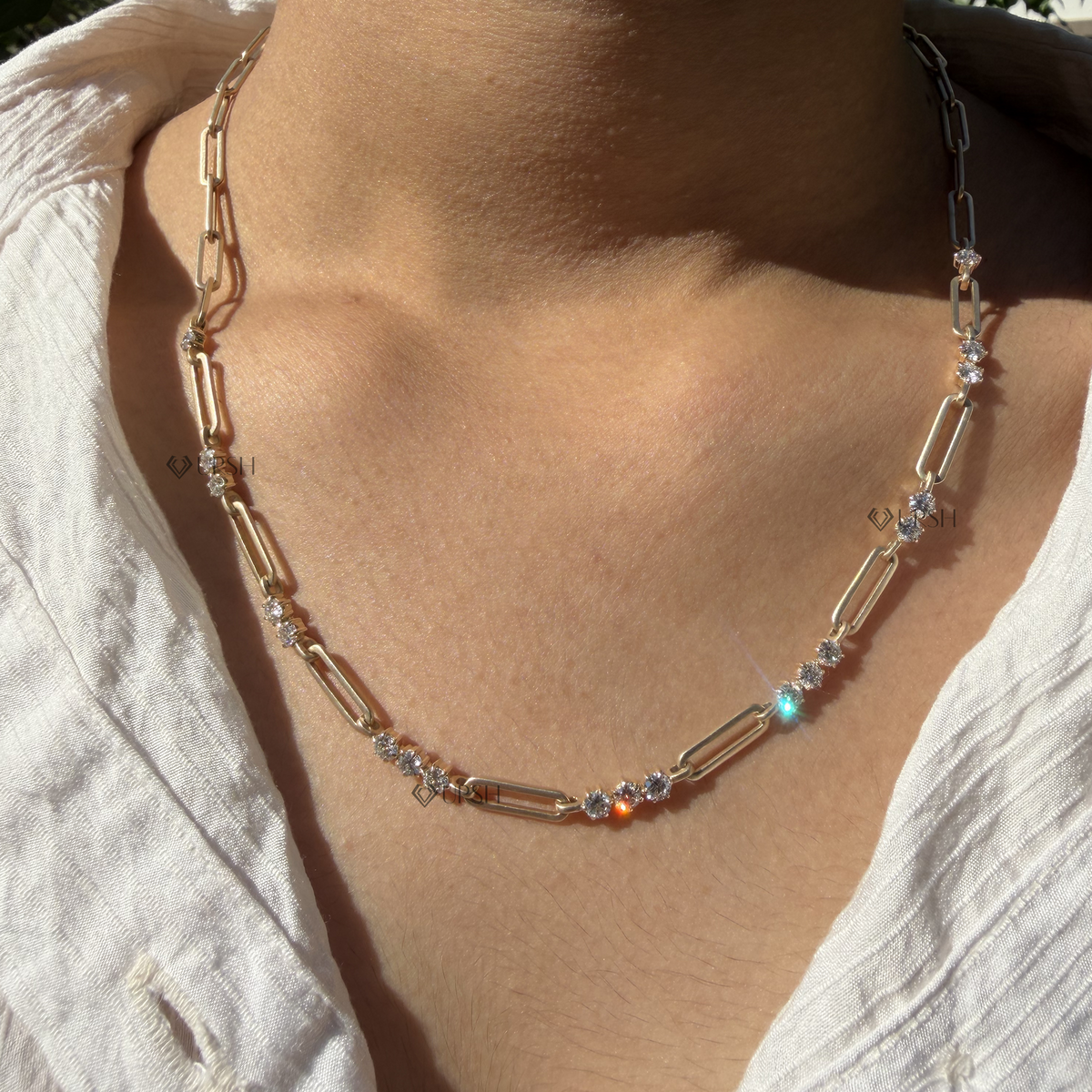 Daylight perspective of yellow gold diamond station paperclip link chain worn against collarbone