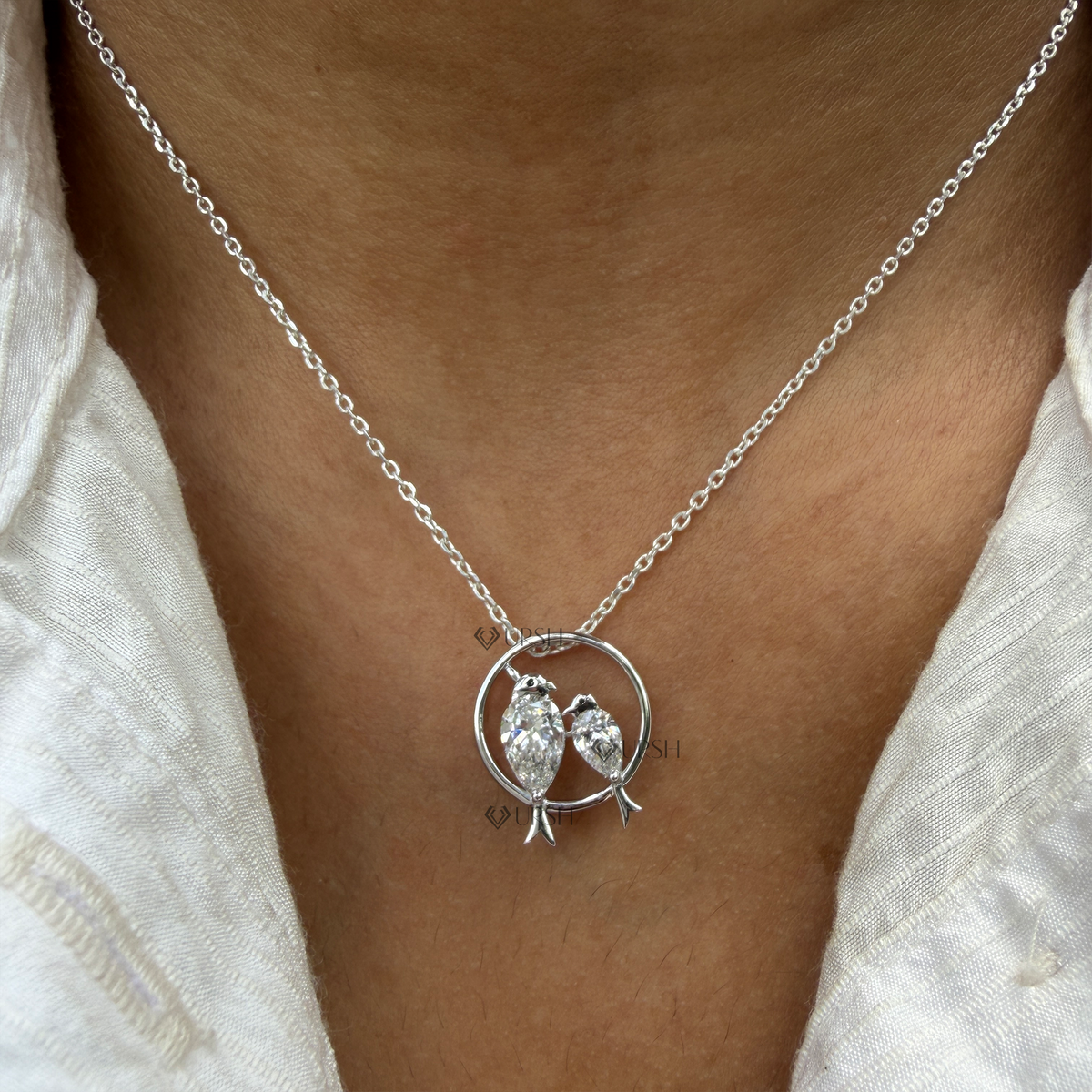 Daylight perspective view of white gold love birds diamond pendant necklace worn on collarbone
