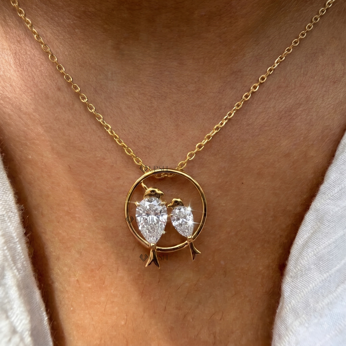 Yellow gold love birds pear cut diamond pendant necklace styled gracefully on neck in natural daylight
