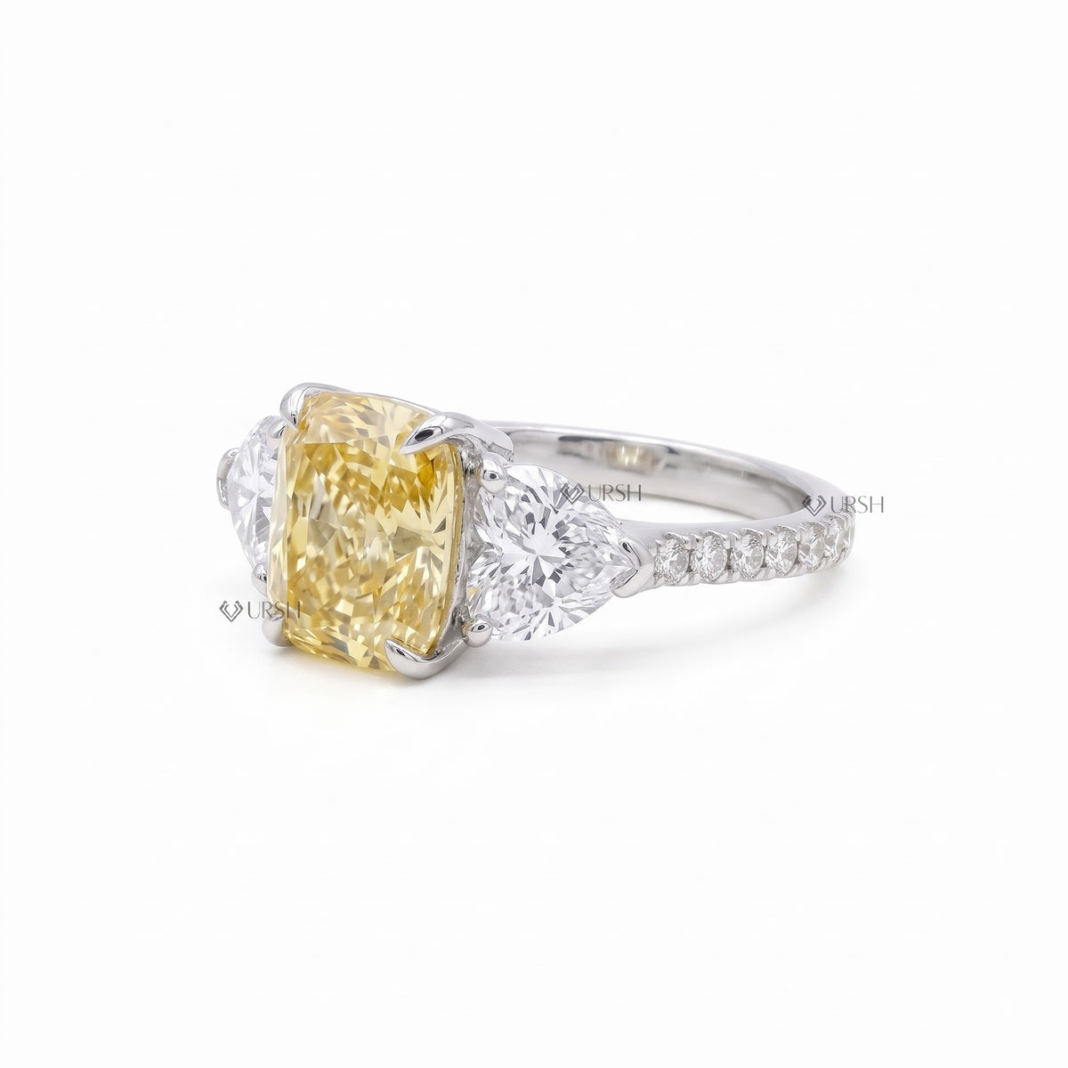 Studio side view of trilogy ring displaying micro-pavé band track and secure multi-stone basket