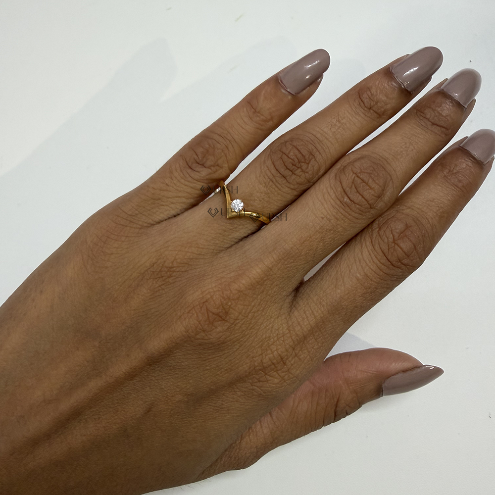 Delicate chevron diamond nesting ring styled on ring finger showcasing graceful finger elongation