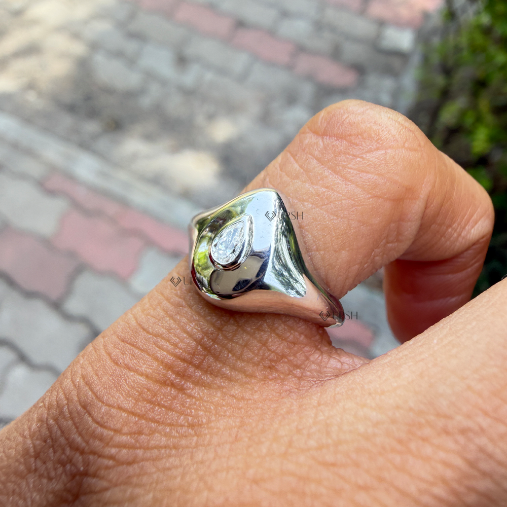 Side angle showing mirror finish and fluid curved volume of white gold pear signet ring