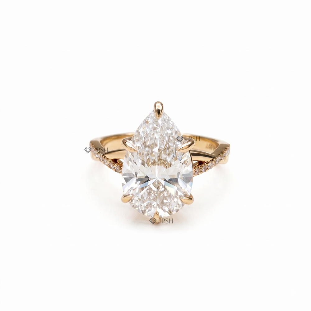 Solid yellow gold pear cut lab grown diamond engagement ring with twisted pavé criss cross shank