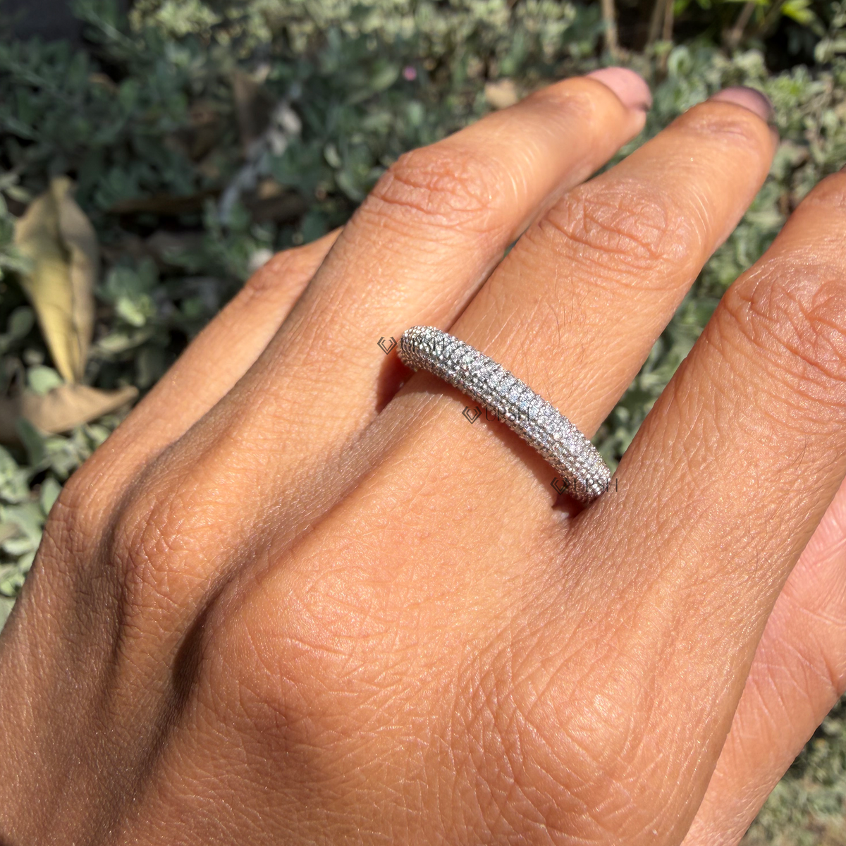 Dome pavé diamond statement band styled gracefully on finger in natural daylight