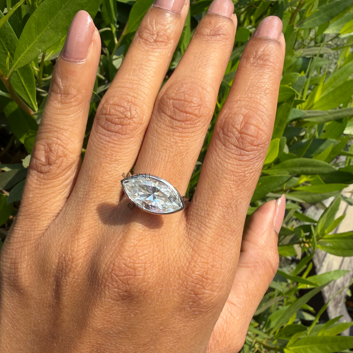 Daylight angle view of horizontal marquise diamond ring worn on hand showcasing modern styling
