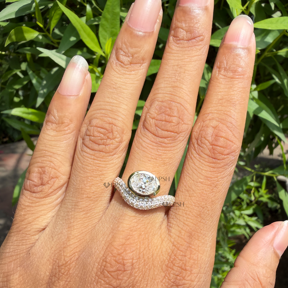 Curved diamond wave statement ring featuring east-west oval bezel styled on hand