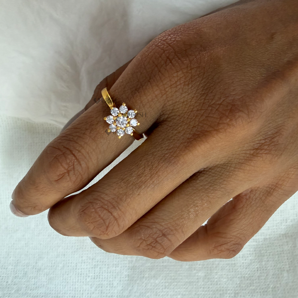Yellow gold diamond blossom ring catching light on hand