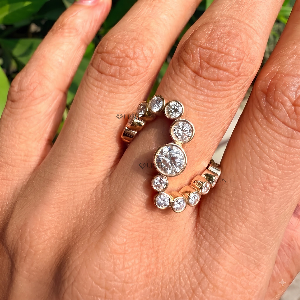 Graduated bezel diamond snake wave ring worn on ring finger against skin tone