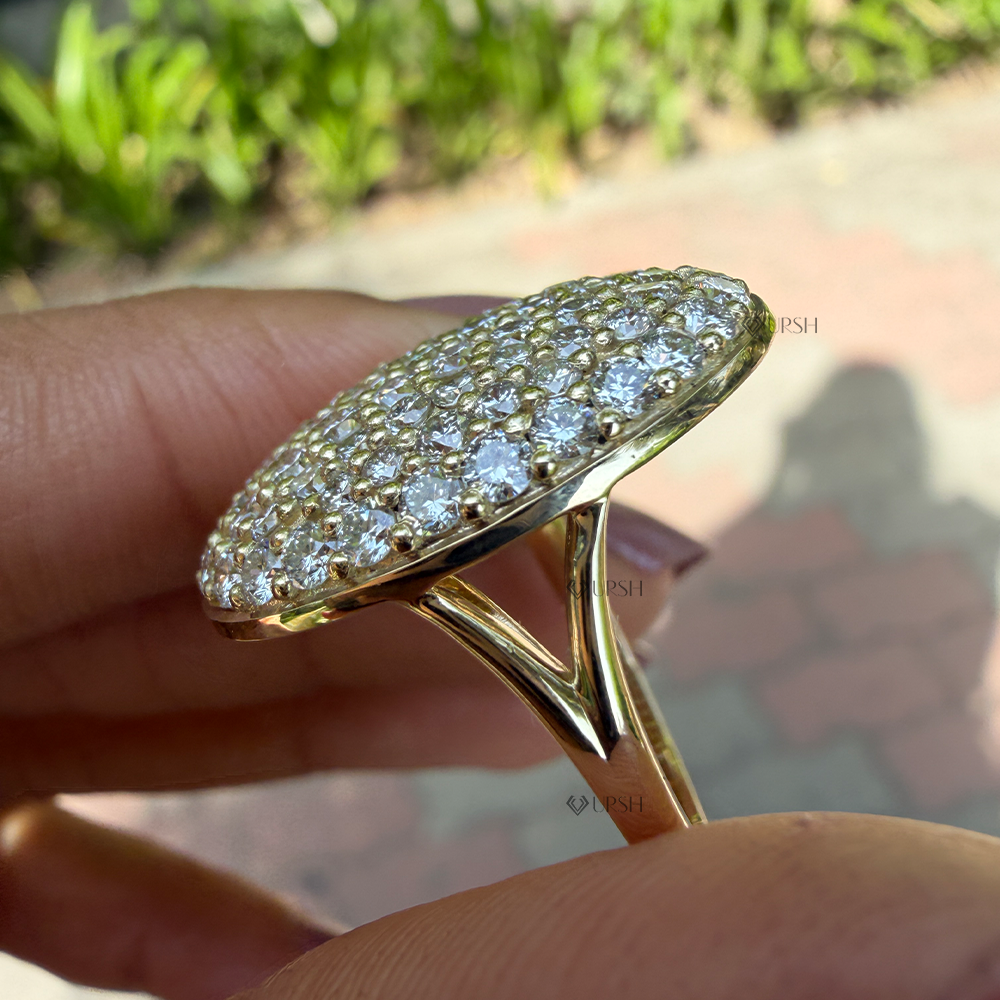 Close-up holding oval disc ring highlighting split band structure and smooth gold under-gallery