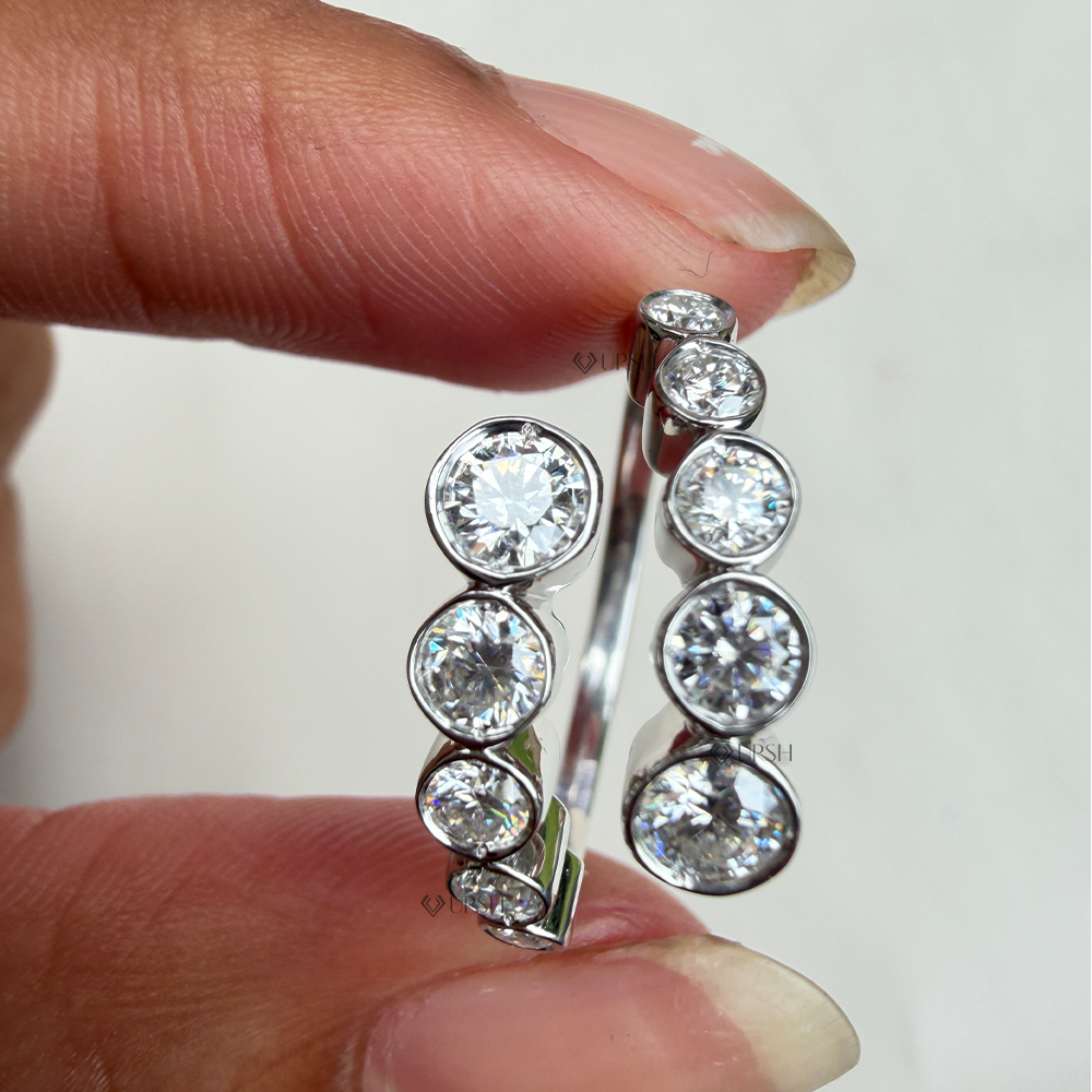 Holding two-tone bypass wrap ring showcasing graduated bezel stone profiles and dual-row structure
