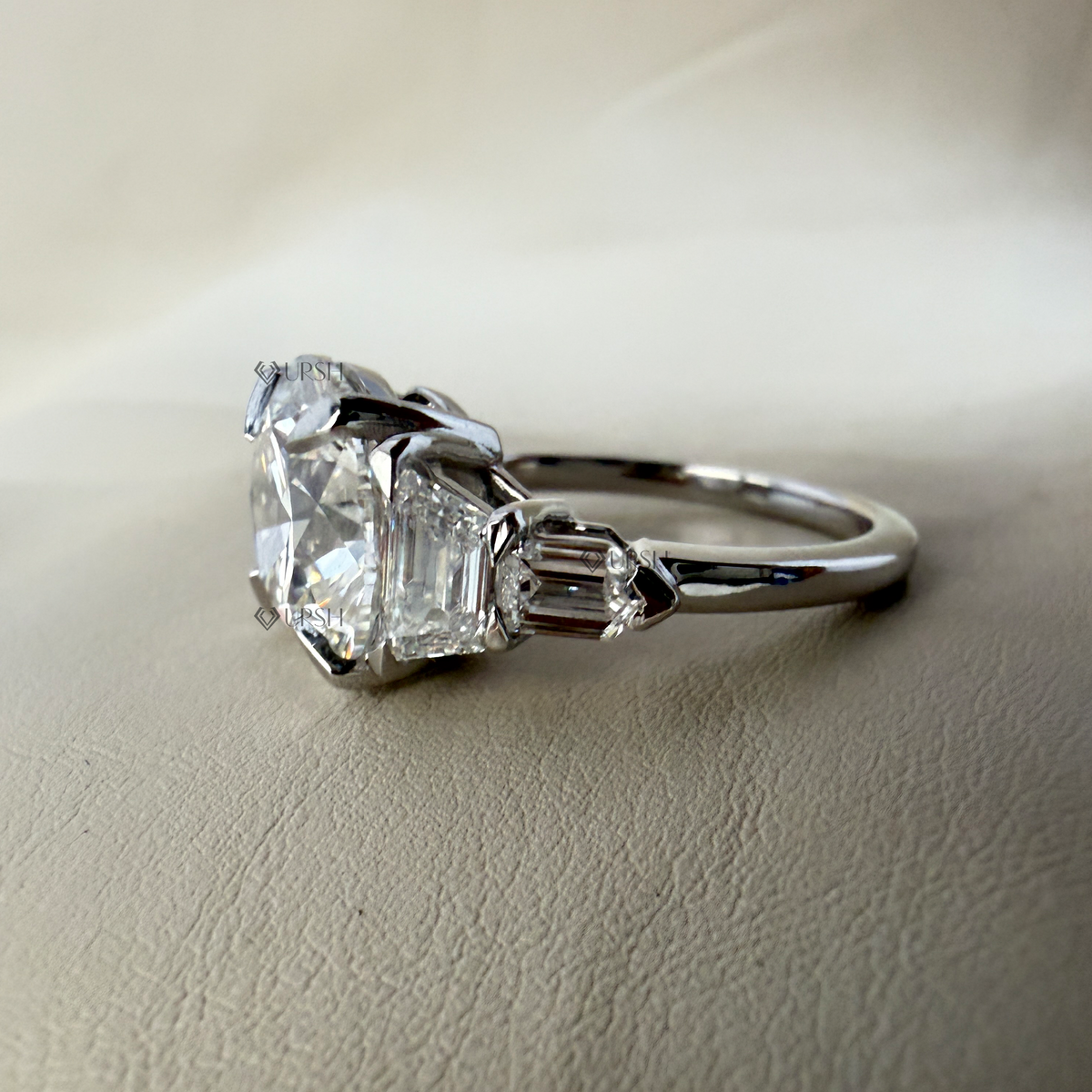 Studio view of multi-stone engagement ring displaying secure prongs and smooth shank taper