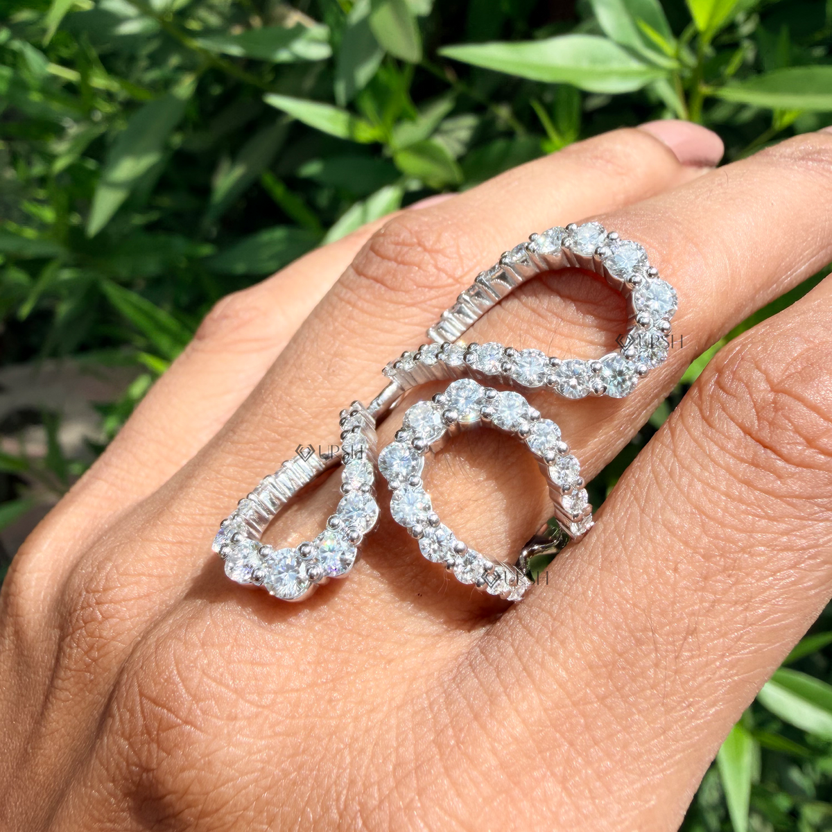 Studio profile view of white gold avant-garde ring displaying raised sculptural loops and mirror finish