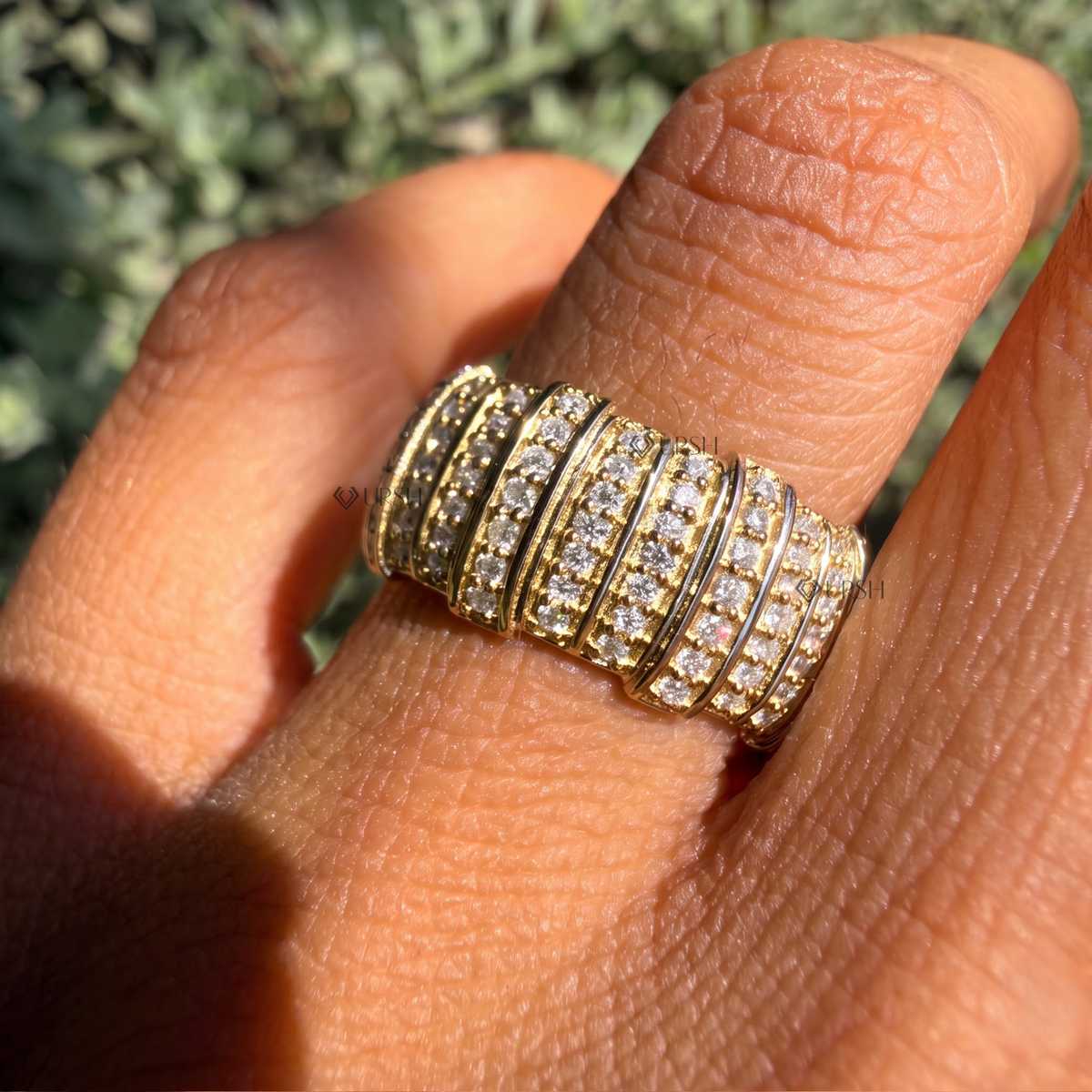 Daylight angle view of multi-row pavé barrel statement ring worn on finger showcasing bold volume