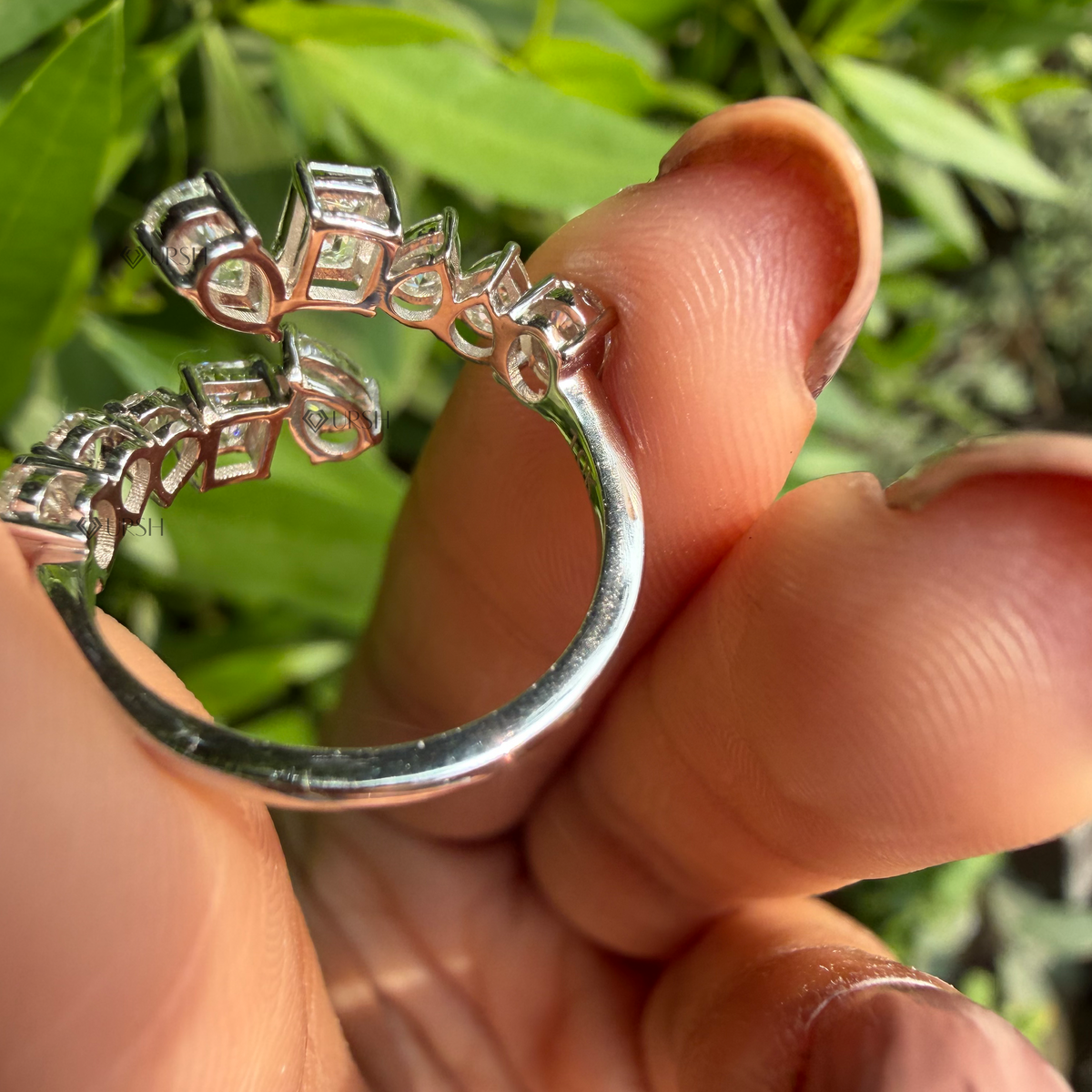 Close-up view of multi-shape bypass wrap ring held against presentation background