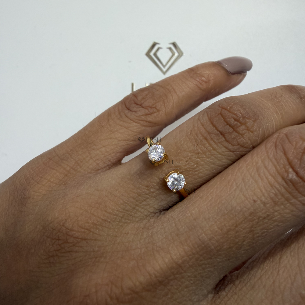 Twin diamond floating open band resting delicately on finger with nude manicured nails