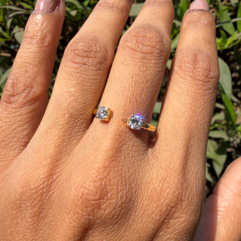 Two stone open diamond cuff band worn on finger in natural outdoor light