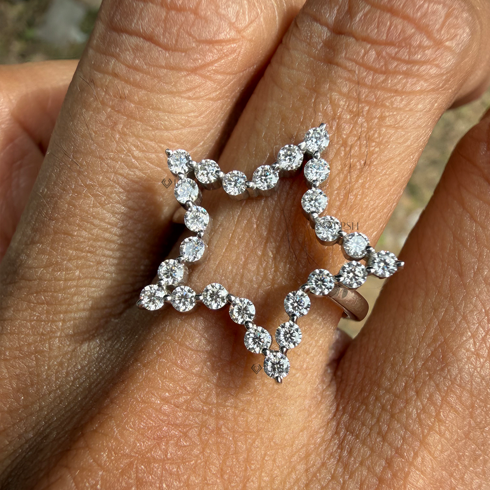 Detailed daylight view showing round diamond sparkle along open star silhouette on hand