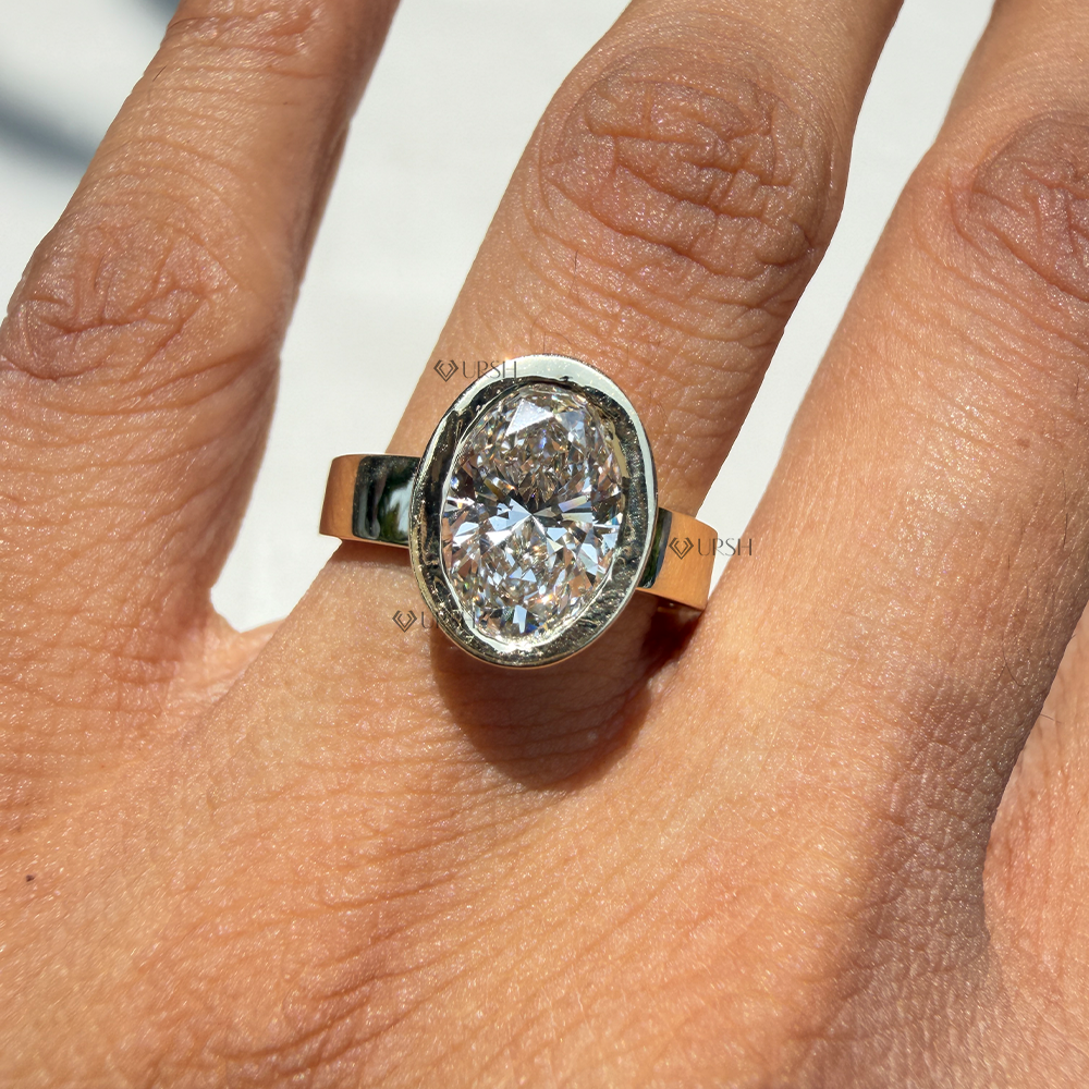 Substantial finger coverage of oval diamond chunky bezel ring in bright daylight