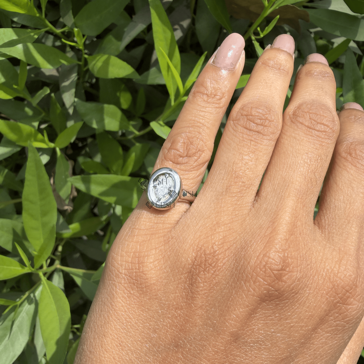 Daylight angle view of oval bezel statement ring worn on hand showcasing bold proportions