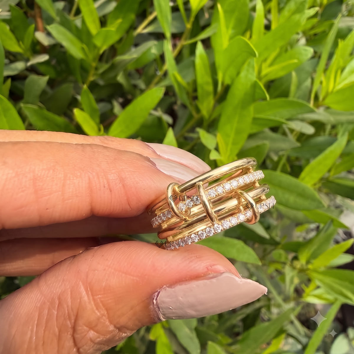 Detailed daylight macro close-up of multi-row pavé diamond link ring showing vertical loops and polished gold strands