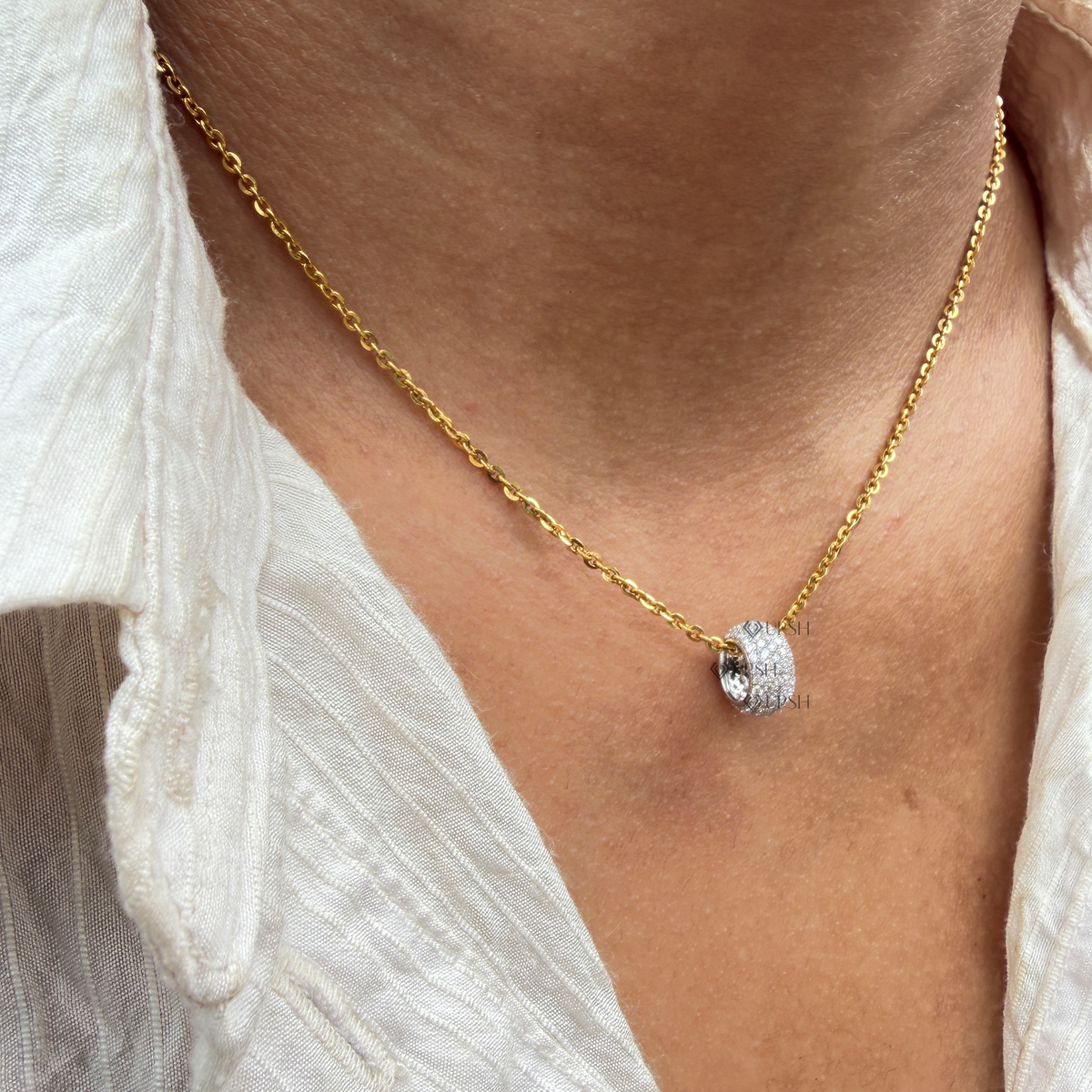Solid white gold pavé diamond rondelle bead charm resting flat on neutral surface