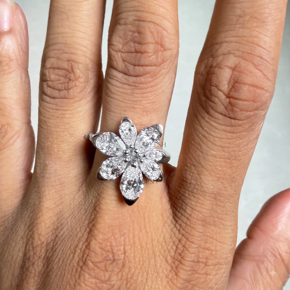 White gold diamond petal statement ring worn on hand showcasing floral bloom silhouette