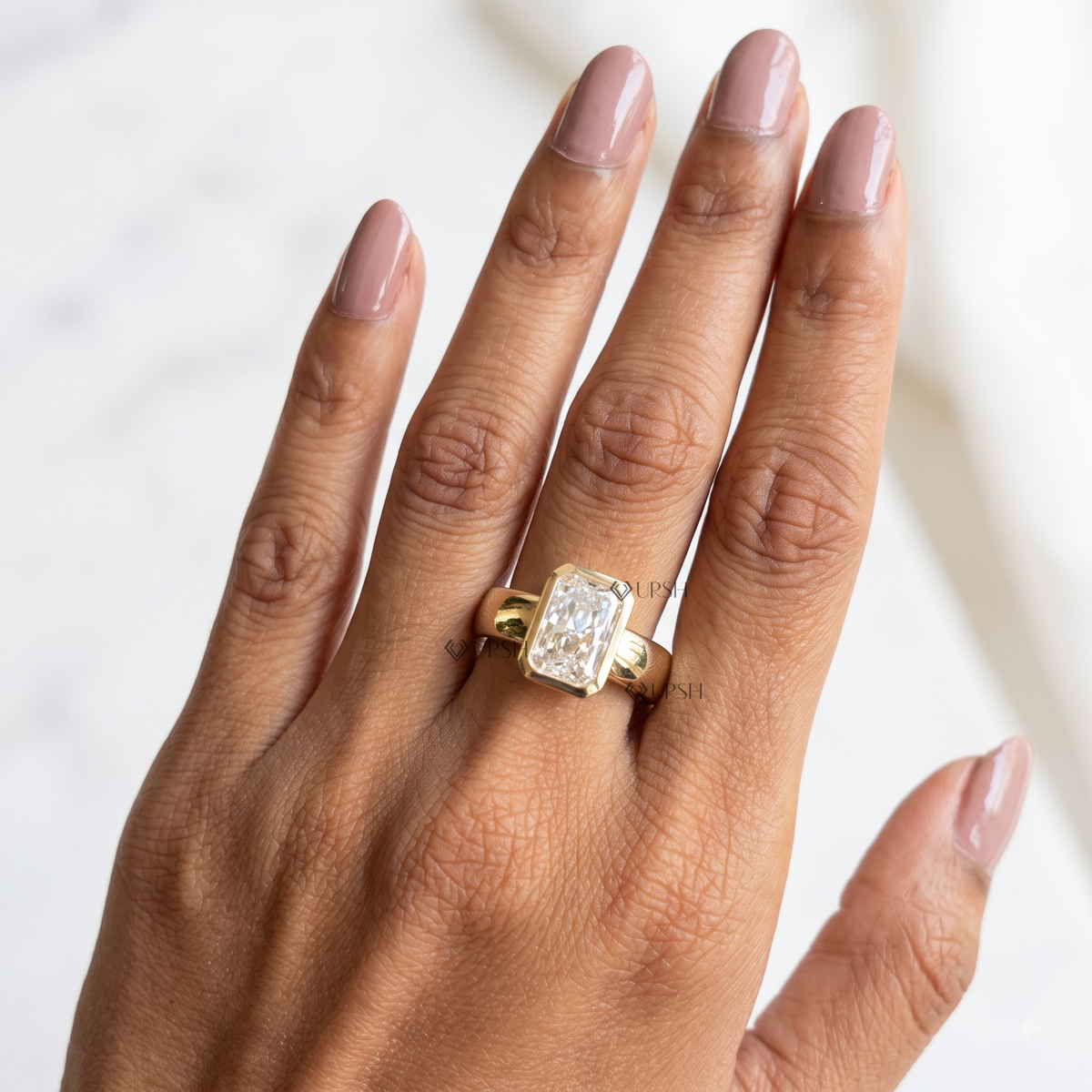 Yellow gold radiant diamond bezel ring worn on hand showing finger coverage