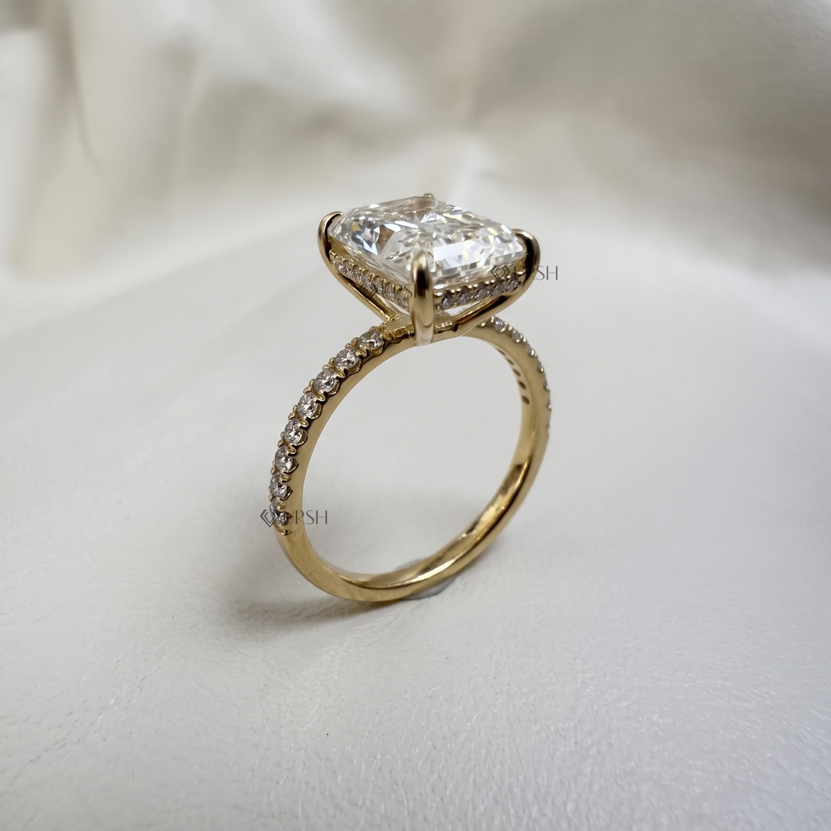 Under-finger view displaying solid gold comfort-fit shank and open gallery basket