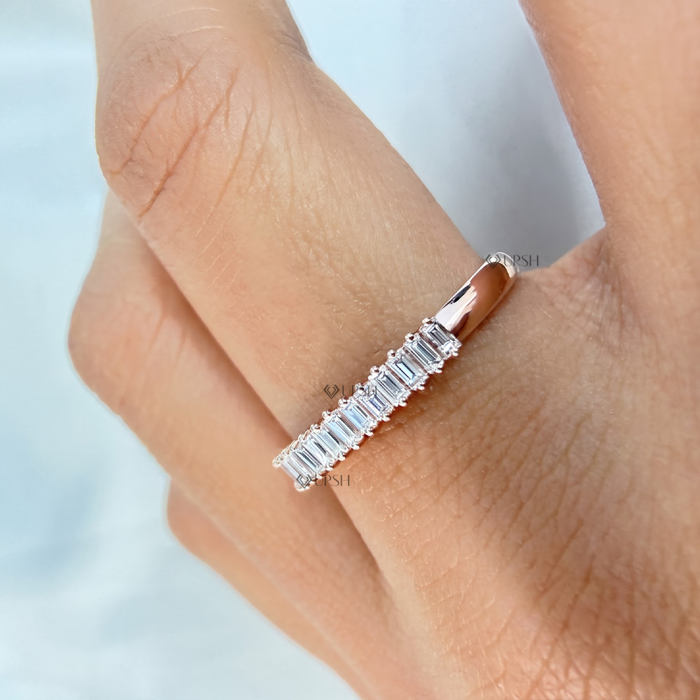 Side angle showing low profile prong alignment and polished shank of rose gold baguette ring