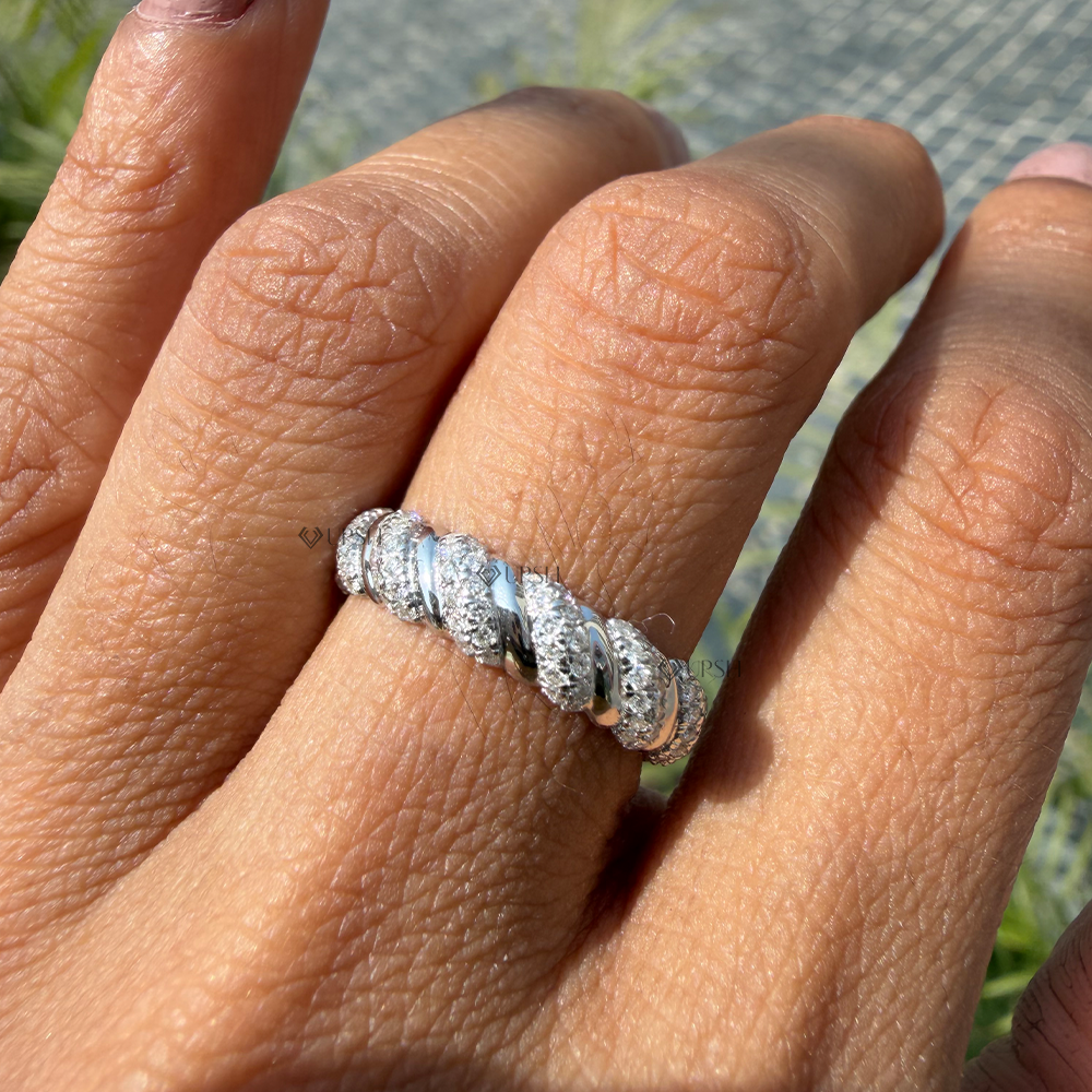 Modern white gold fluted diamond wedding band styled elegantly on finger