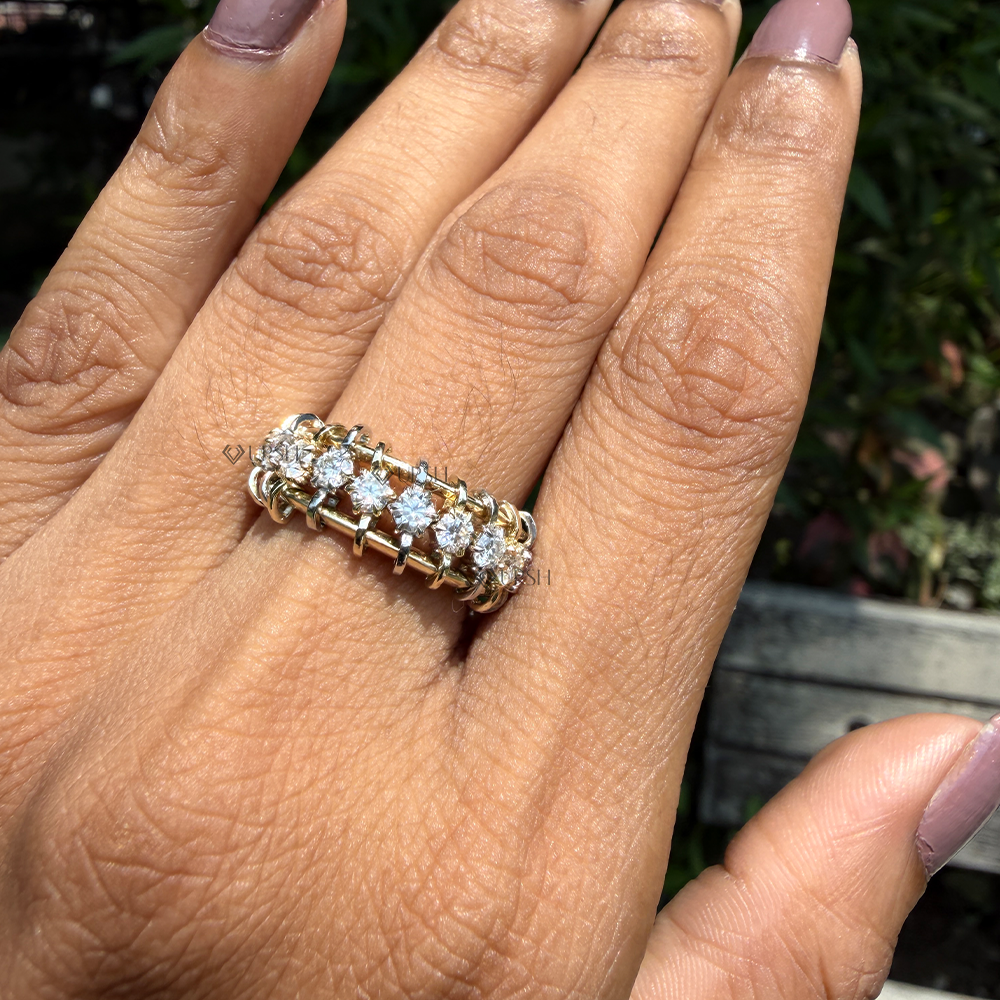 Architectural two-tone diamond ladder statement ring styled across index finger in daylight