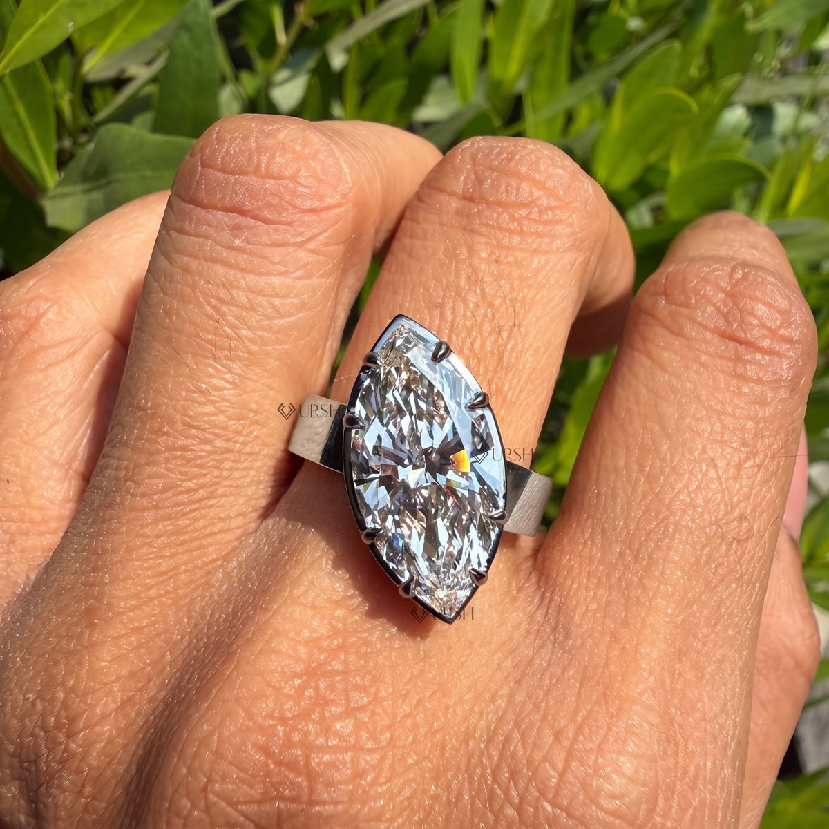 White gold wide statement navette cigar ring worn gracefully on hand in daylight