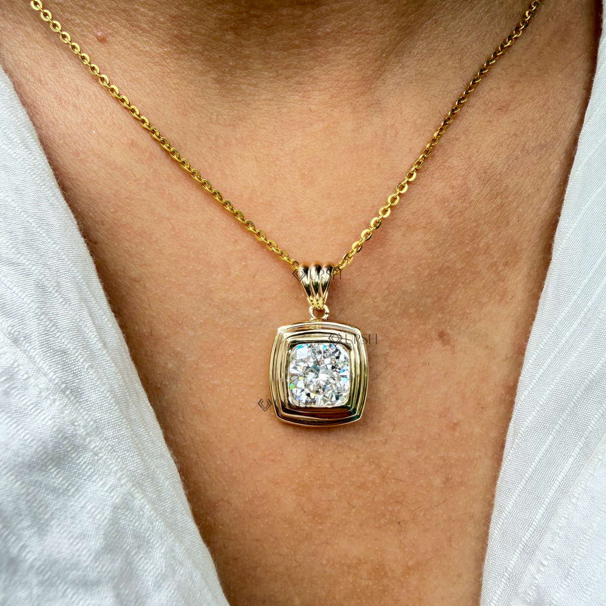 Daylight perspective view of yellow gold cushion cut solitaire pendant necklace worn on neck