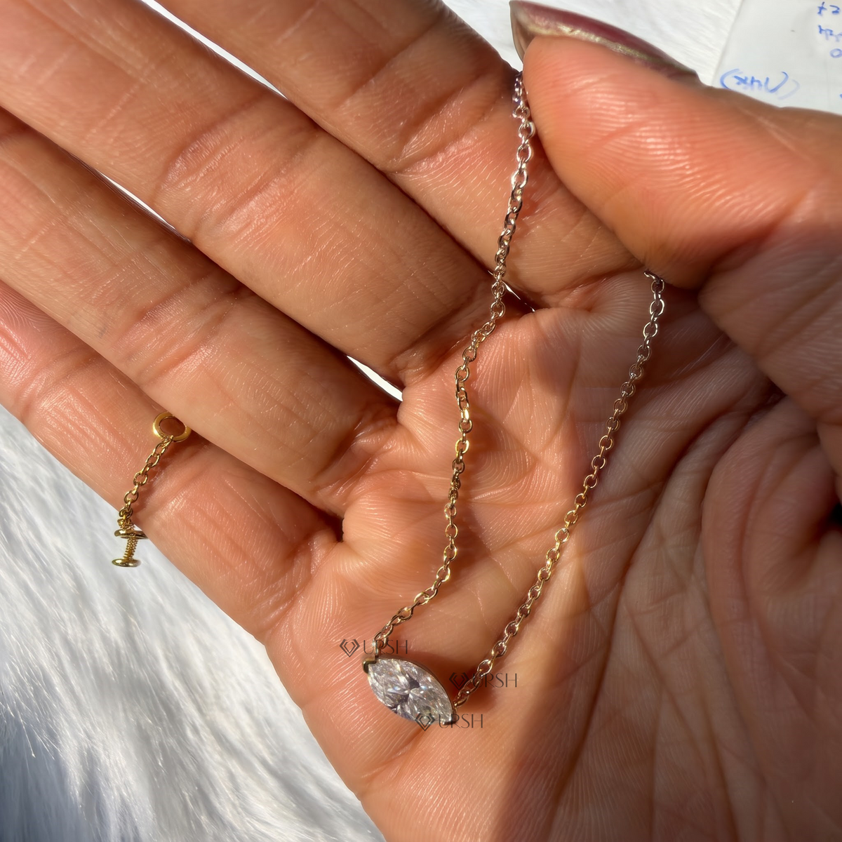 Detailed hand model view of horizontal east-west marquise diamond pendant held gracefully