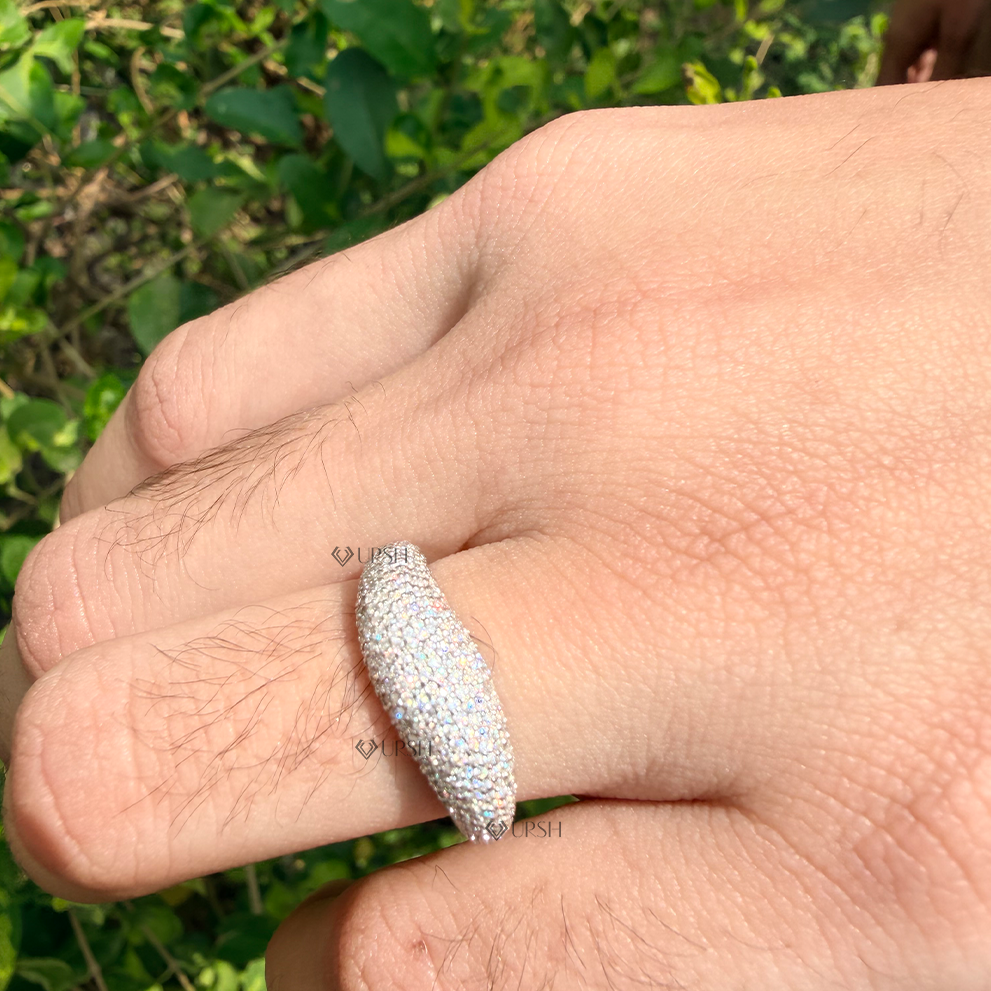 Full pavé tapered dome statement ring worn on finger against natural background displaying high brilliance