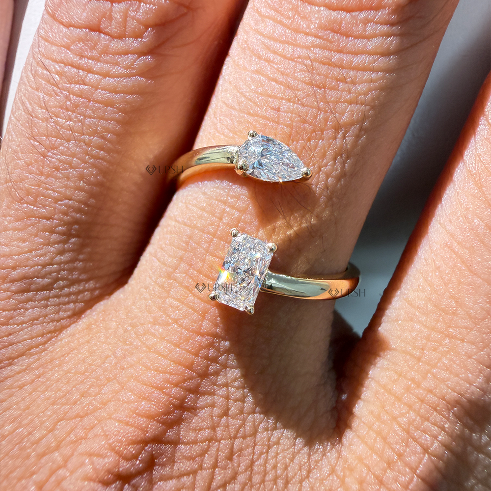 Close-up view of radiant and pear cut diamond brilliance on yellow gold open wrap band