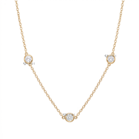 Solid yellow gold three stone bezel set diamond station cable chain necklace featuring round lab-grown diamonds floating along a delicate chain