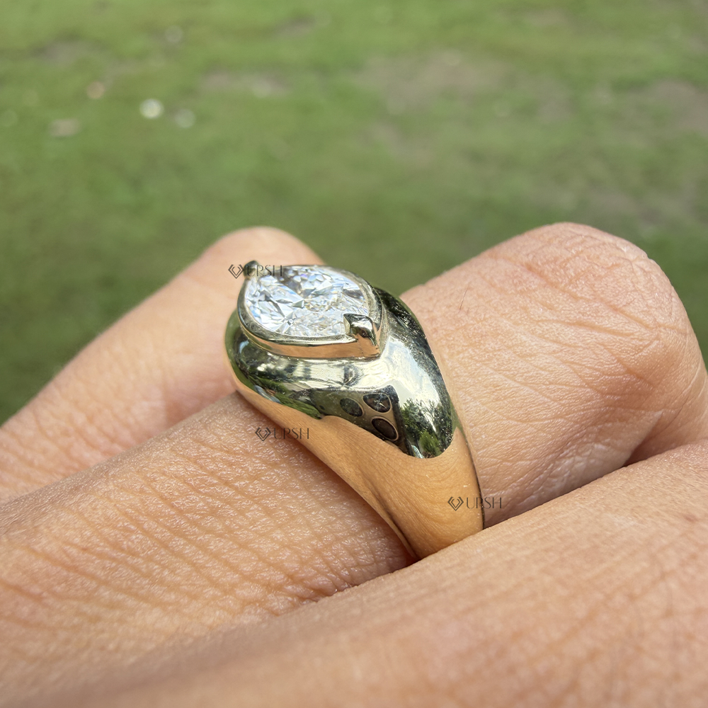 Side angle showing low-profile thick bezel setting of east west marquise diamond ring
