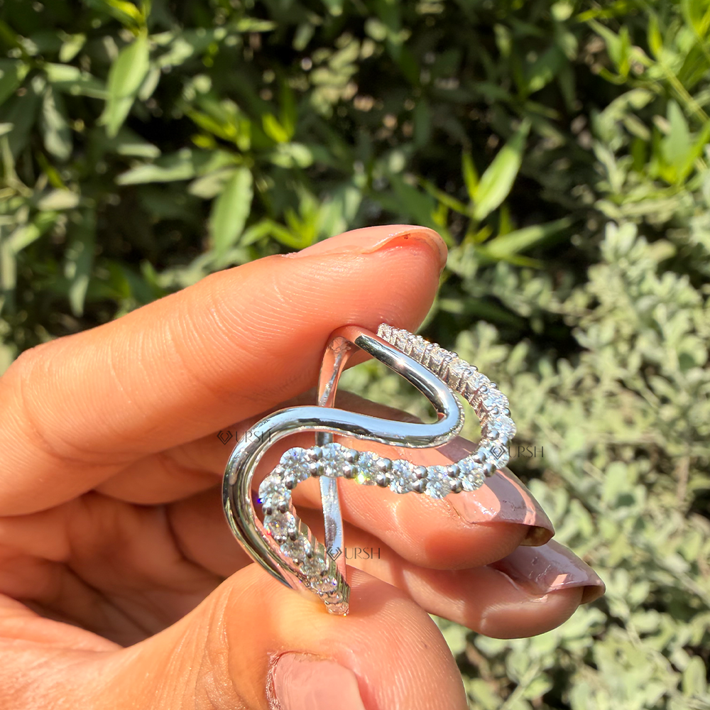 Side angle holding white gold wave ring highlighting two-tier ribbon contours