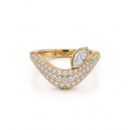 Solid yellow gold asymmetrical wave statement ring featuring a bezel marquise diamond tipping a dense pavé dome band