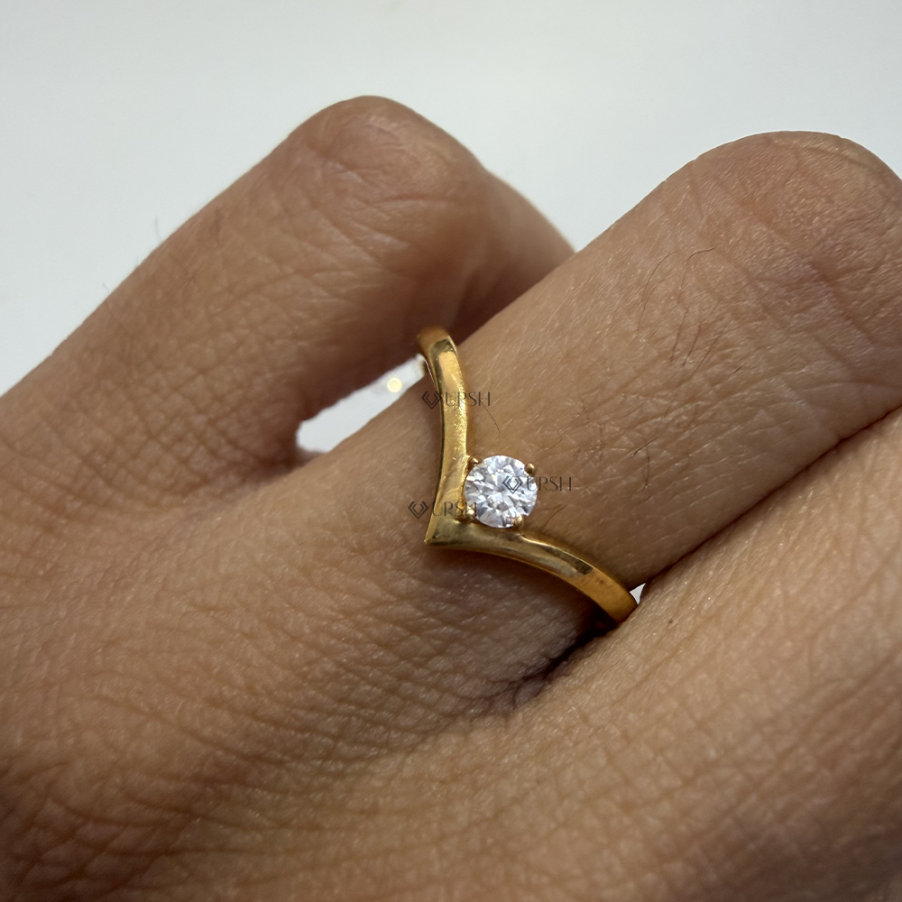 Detailed daylight close-up showing polished yellow gold V-curve band and sparkling round lab diamond on hand