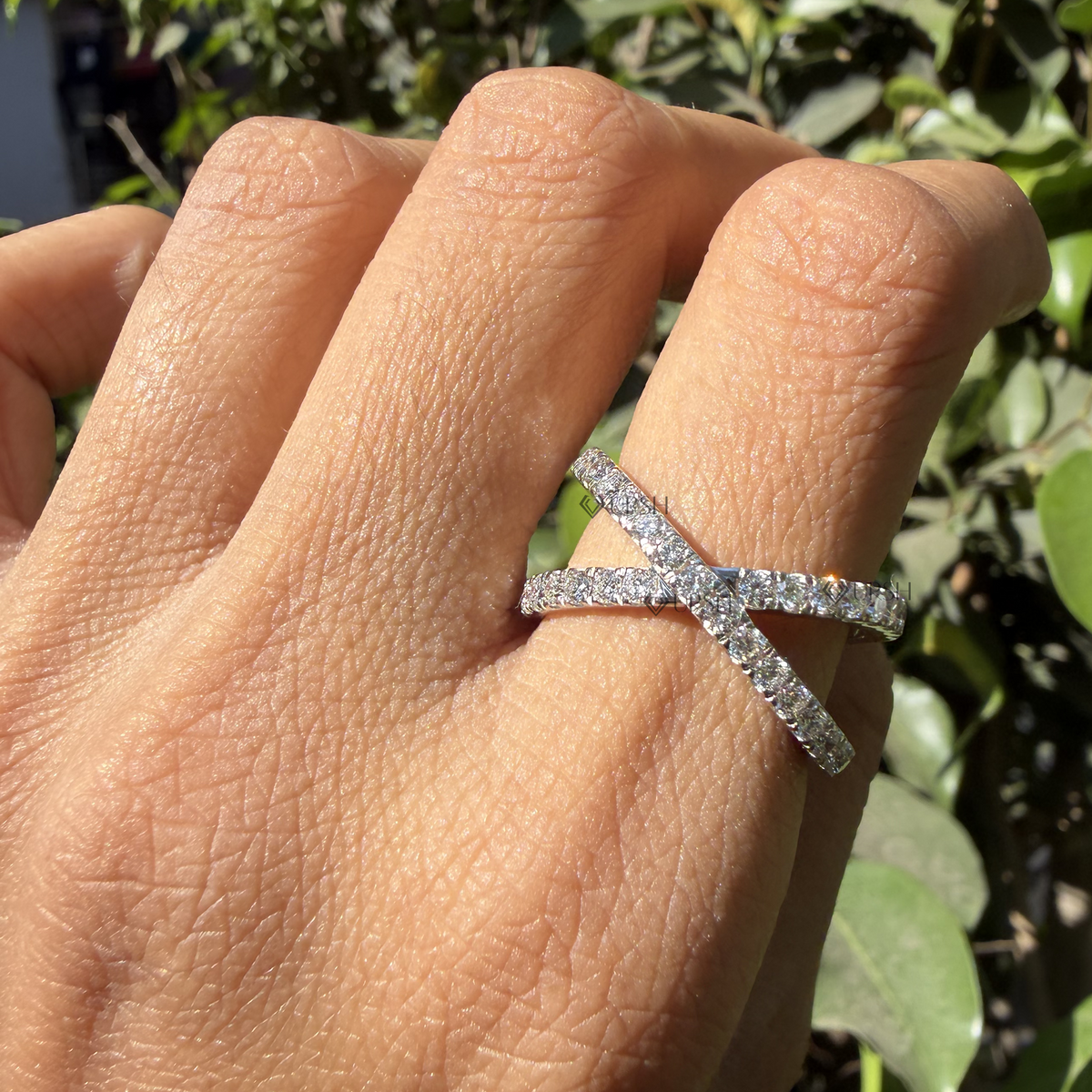 Striking X-shaped crossing pavé ring worn on hand showcasing bold fashion proportions