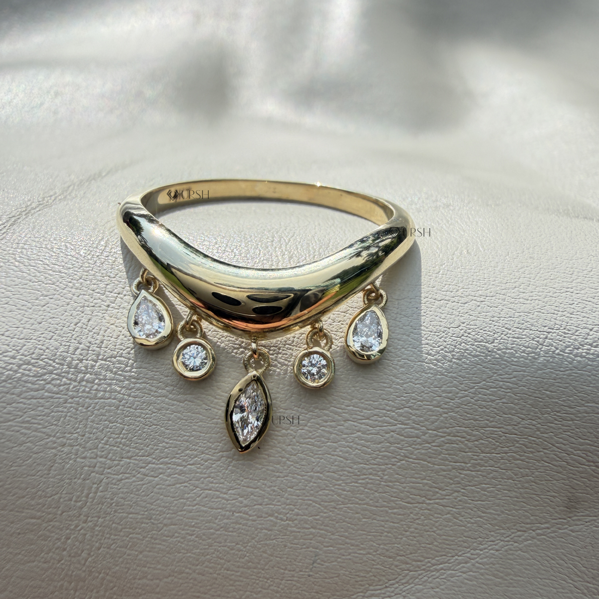 Side angle showing movement and articulation of hanging diamond charms on solid gold wishbone ring