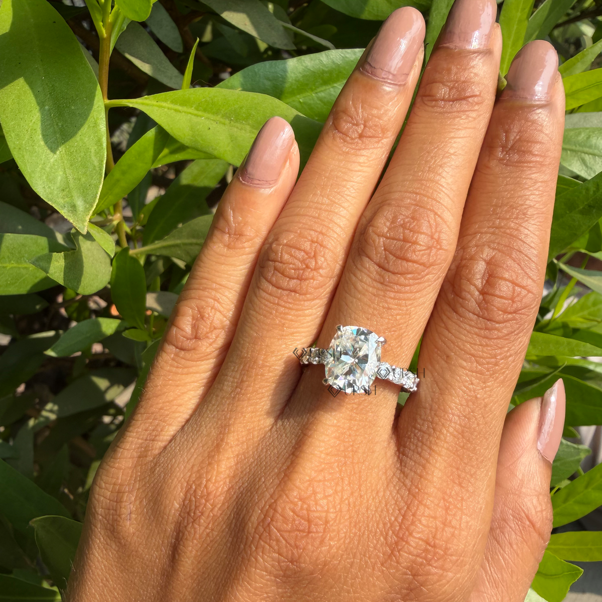 Daylight angle view of cushion cut lab diamond engagement ring worn on hand showcasing brilliance