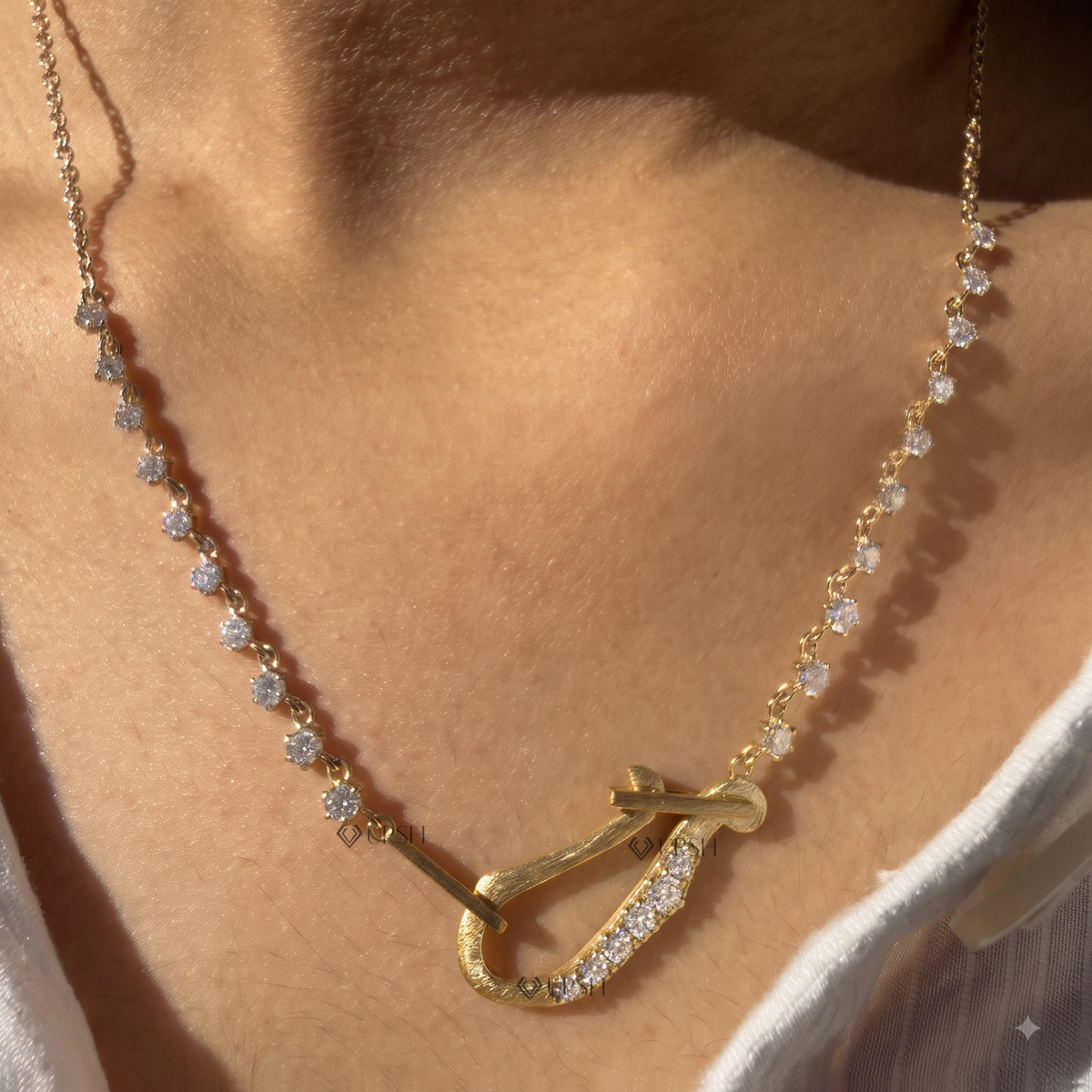Daylight perspective of yellow gold carabiner hook diamond station chain worn on neck