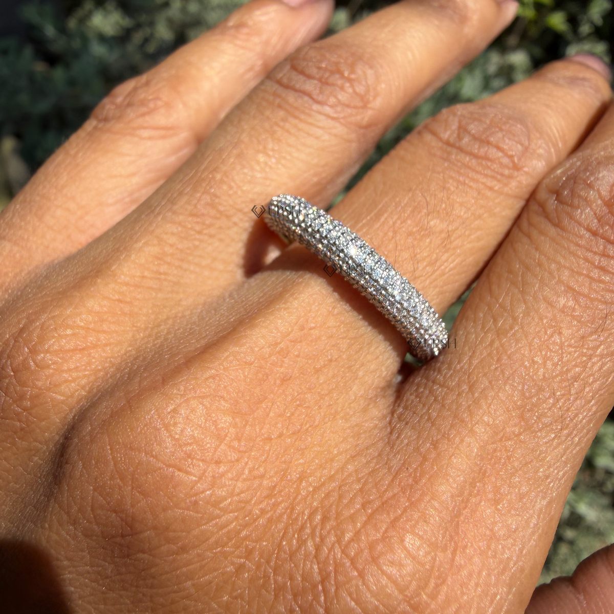 Daylight angle view of chunky domed diamond ring worn on hand showcasing brilliant coverage