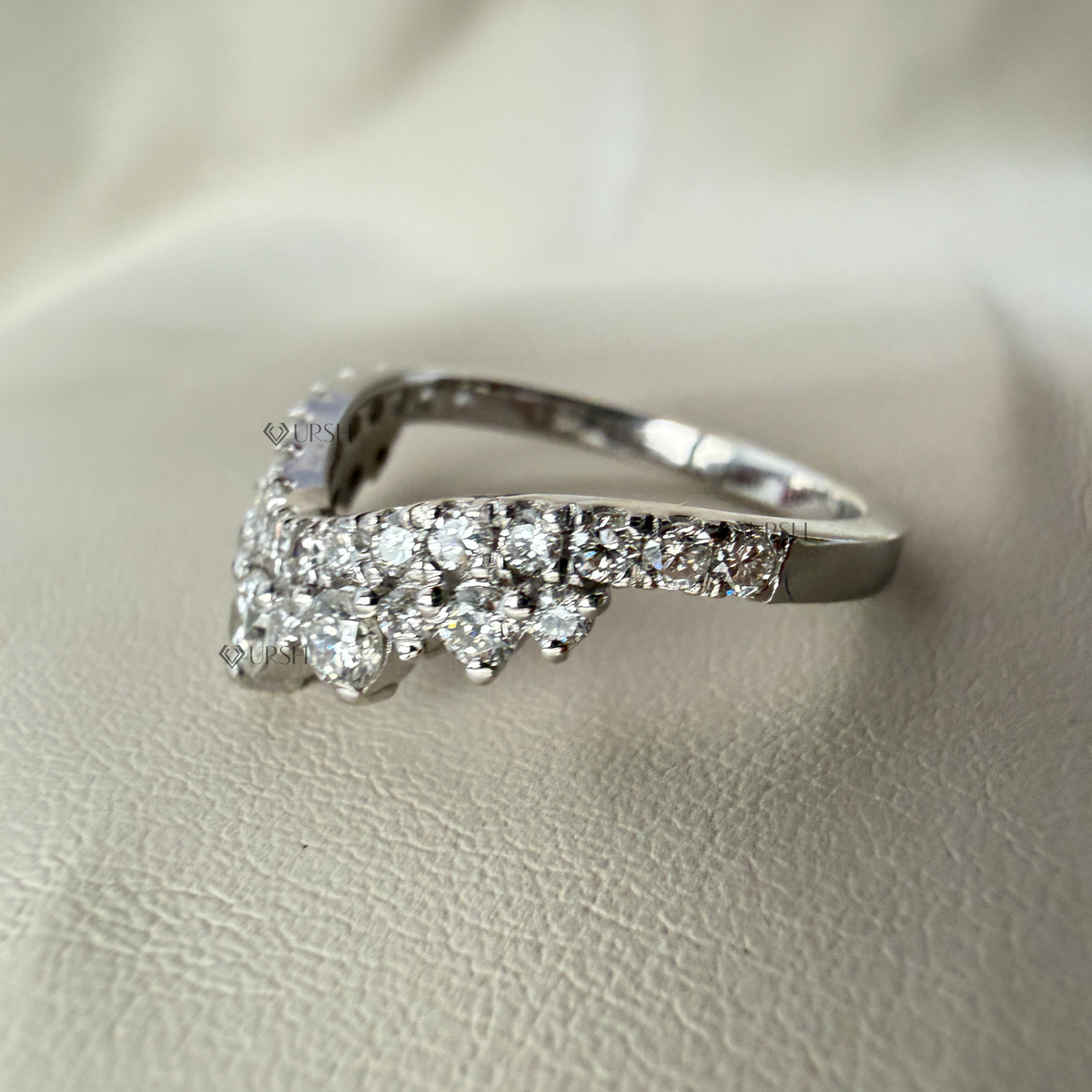 Side angle holding white gold contoured crown ring showing curved profile and band thickness