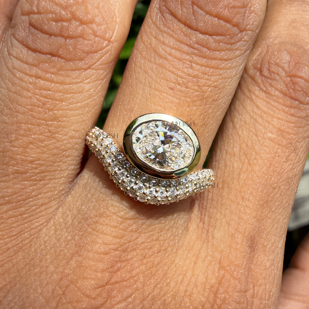 High-clarity sparkle of horizontal oval lab diamond nested inside sweeping micro pavé band