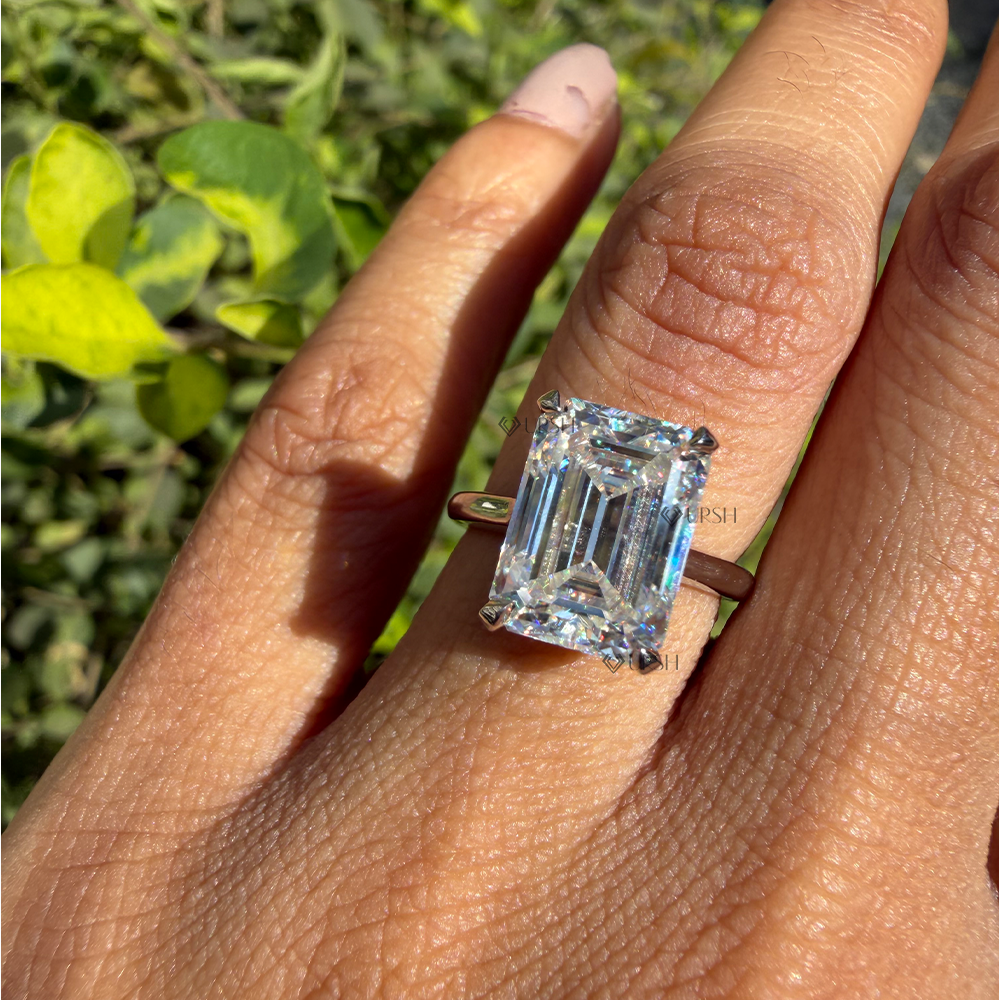 Detailed daylight sparkle and hall of mirrors facet reflection of emerald cut lab diamond on hand