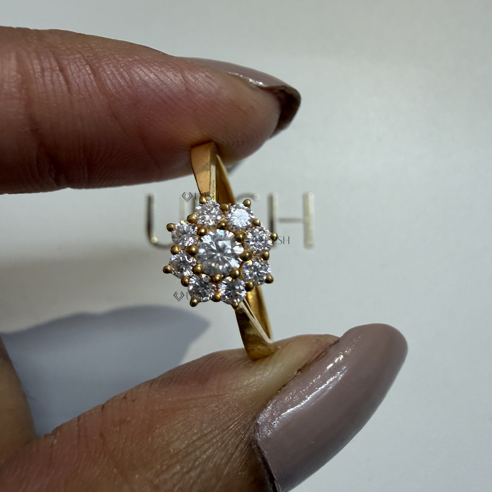 Close-up holding solid gold starburst diamond ring displaying round petal prongs